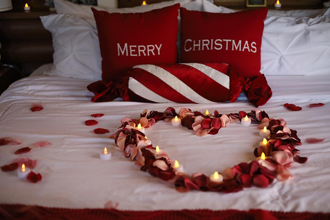 romantic getaway bed with roses secret box cabin blue ridge ga
